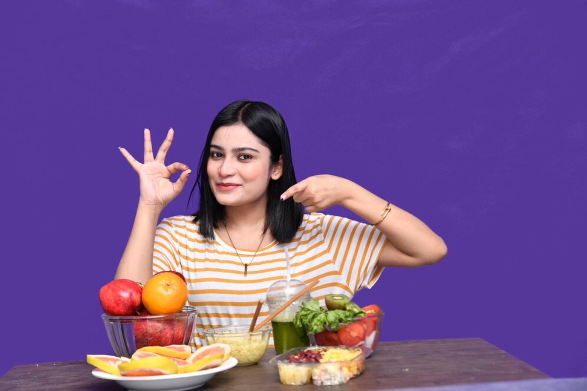 Young woman smiling at camera, making an 